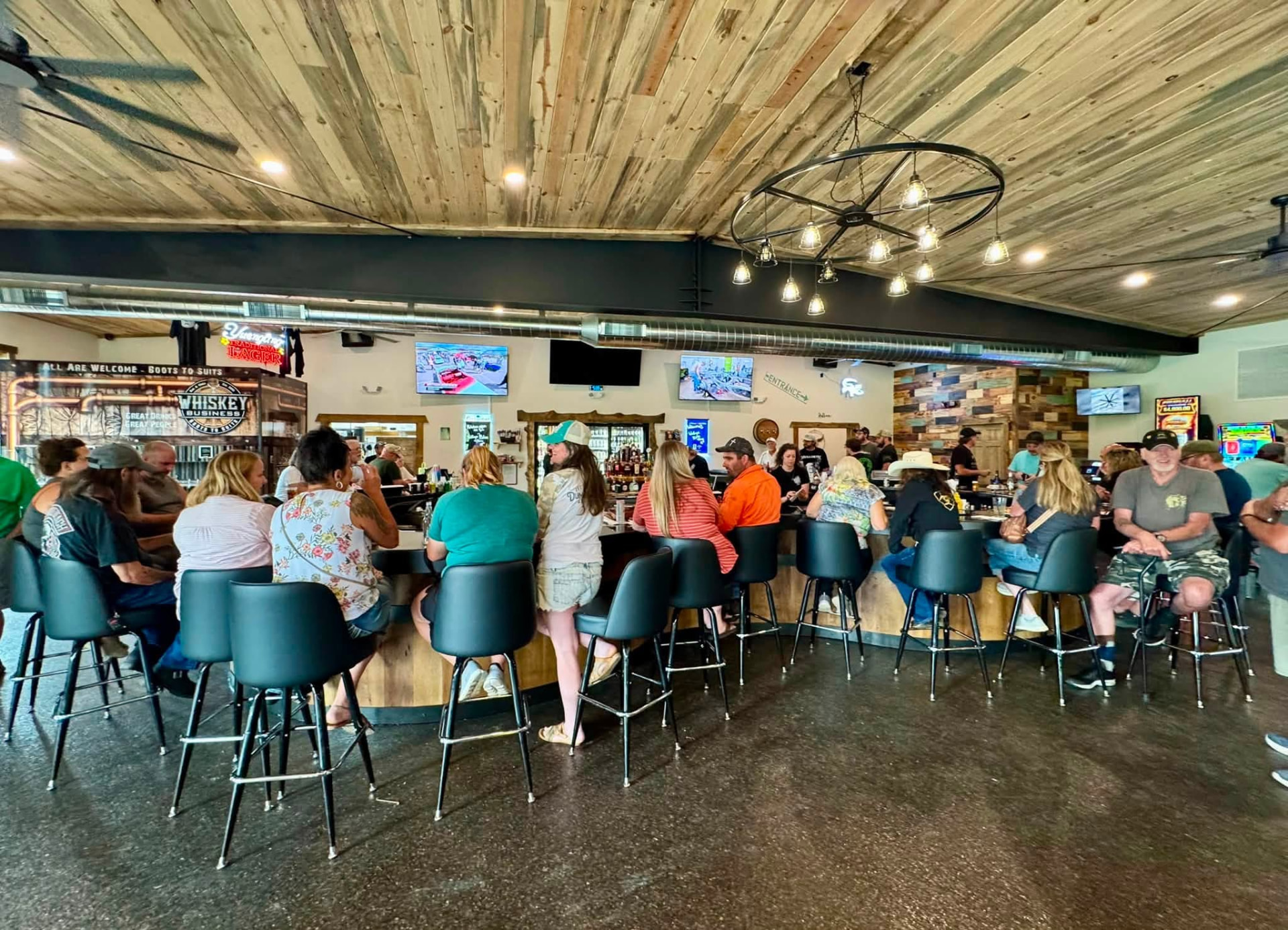 Guests gathered around the bar at Whiskey Business