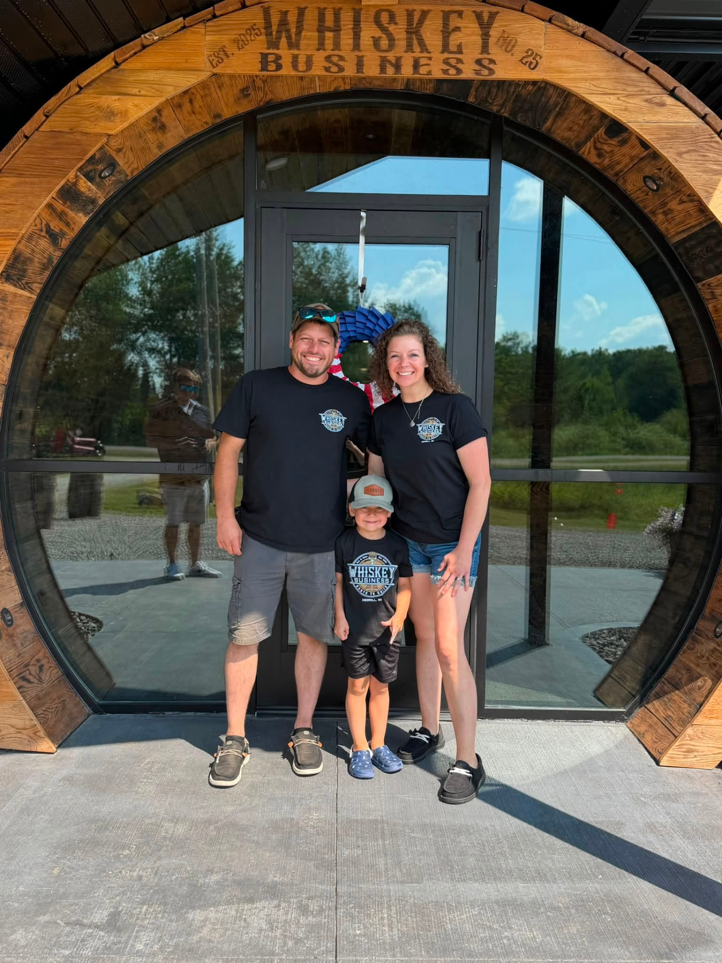 Family standing at the Whiskey Business barrel door entrance